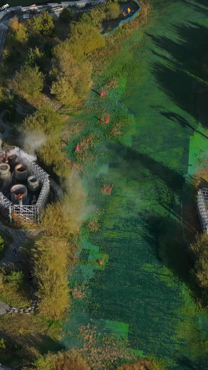 Aerial drone view of CopenHill artificial ski slope on the roof of an energy plant. Vertical