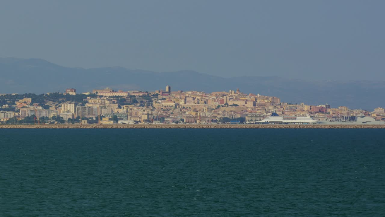Panoramic view of Pula Cagliari in Sardinia seen from the serene waters.