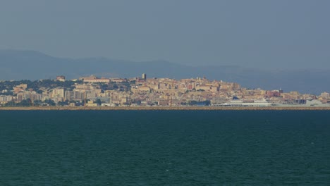 panoramic view of pula cagliari in sardinia seen from the serene waters.