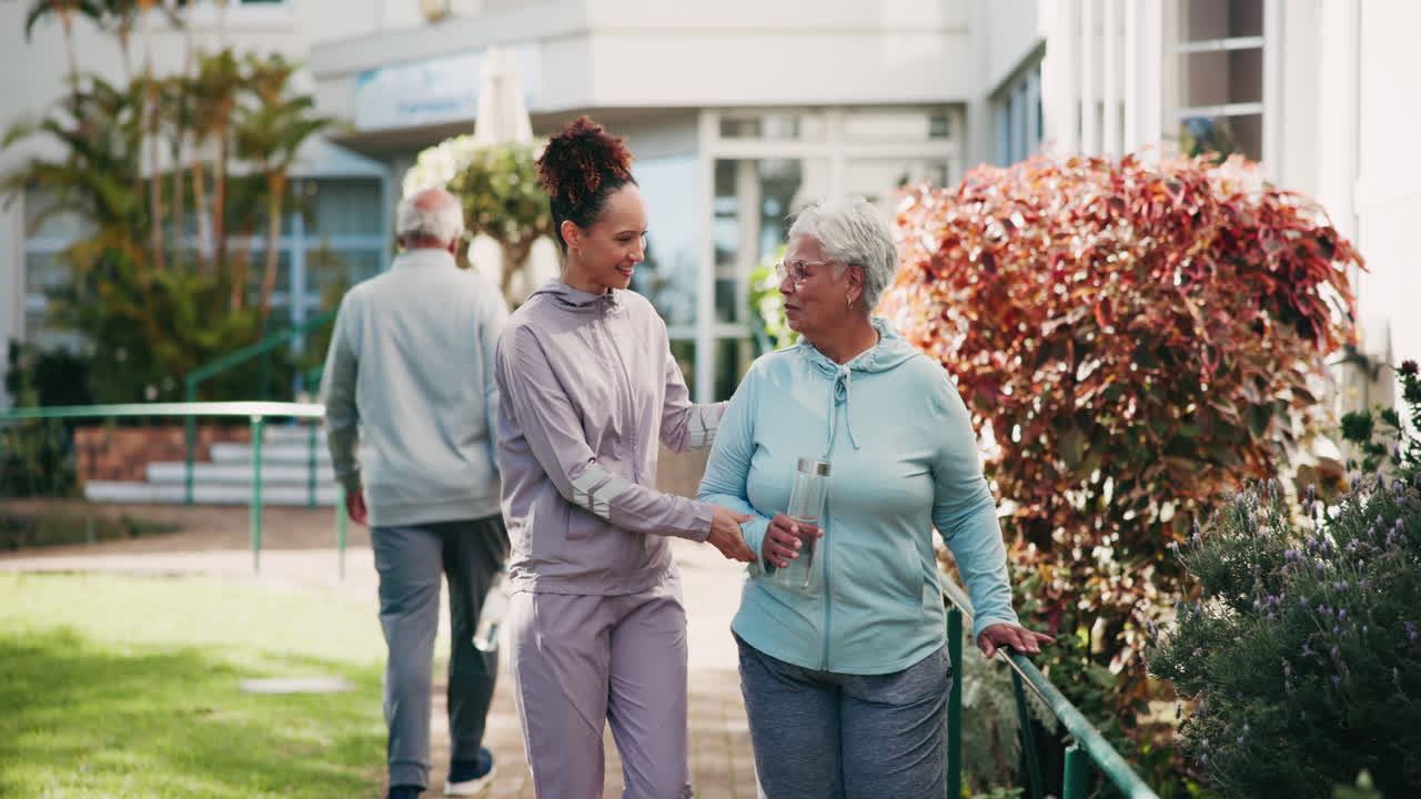 Elderly people exercising with caregiver