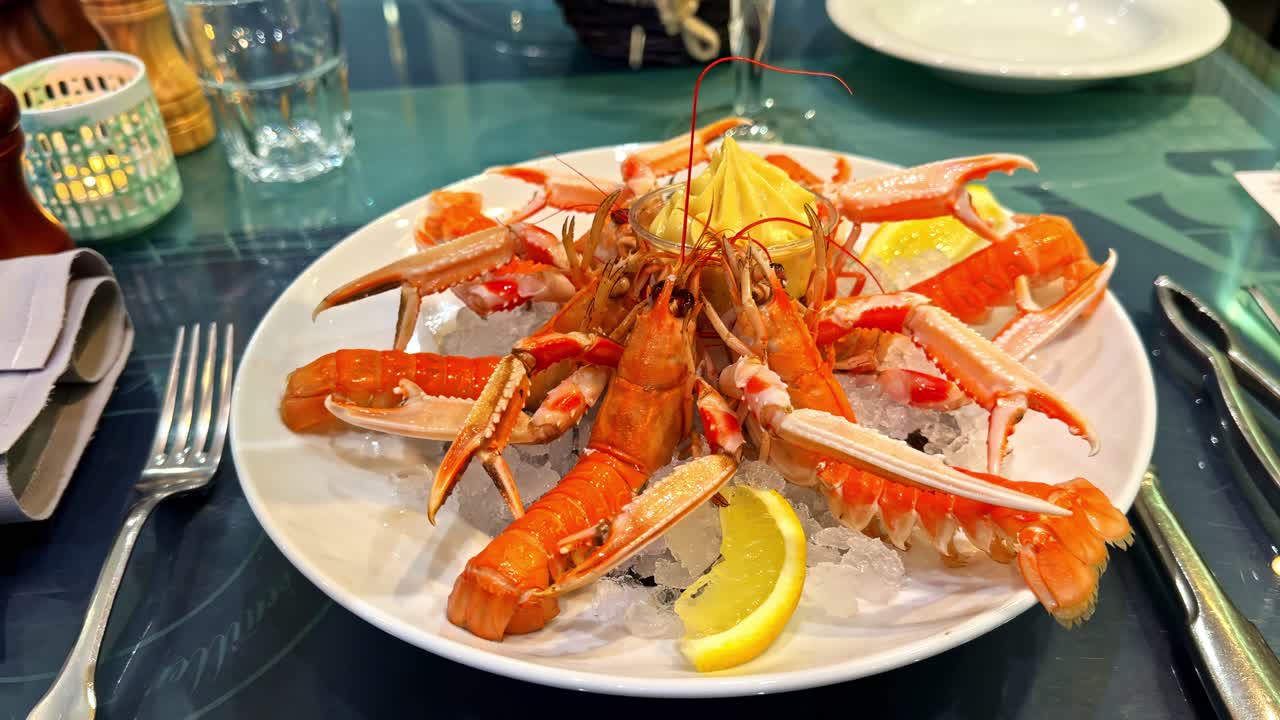 Cooked Langoustines Served Cold On A Bed Of Ice, Garnished With Lemon Slices
