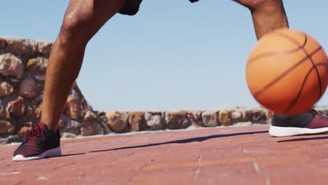 senior african american man exercising playing basketball by the sea