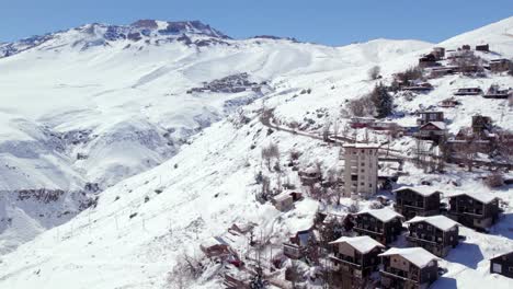 fly over farellones with view to the exclusive ski resort of la parva completely snowed in chile, sunny day