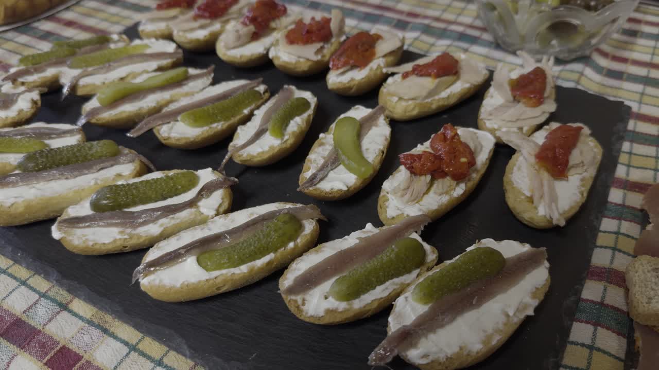 Delicious Tapas Displayed Over Black Plate And A Colourful Tablecloth