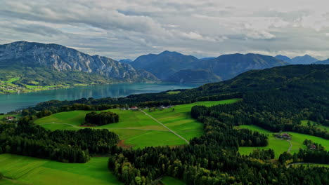 Village,-green-fields-and-trees-in-spectacular-mountain-lake-landscape