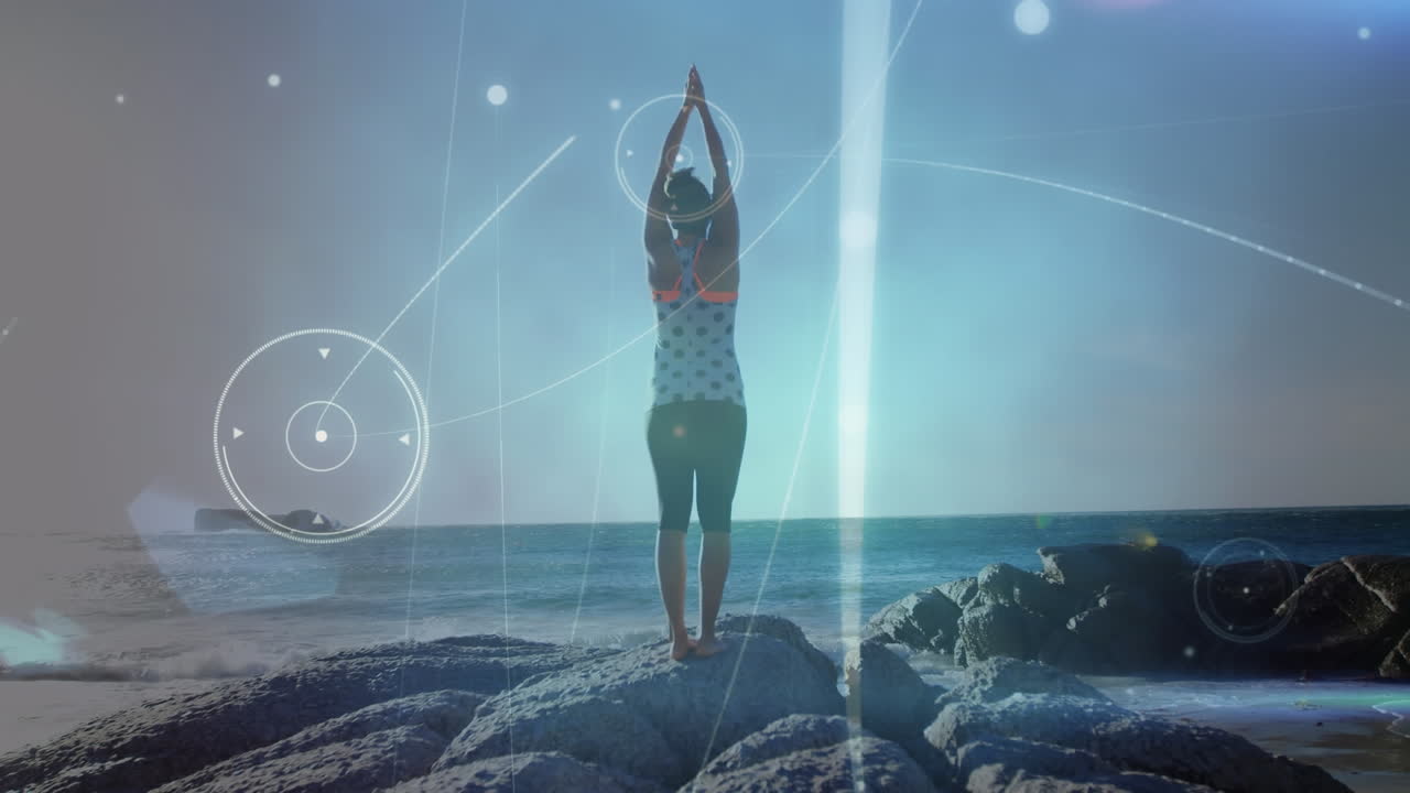 Animation of globe over woman practicing doing yoga