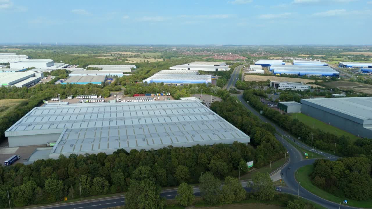 Wide orbit aerial drone view of business retail park and distribution warehouses at Magna Park Lutterworth England UK summer evening logistics landscape