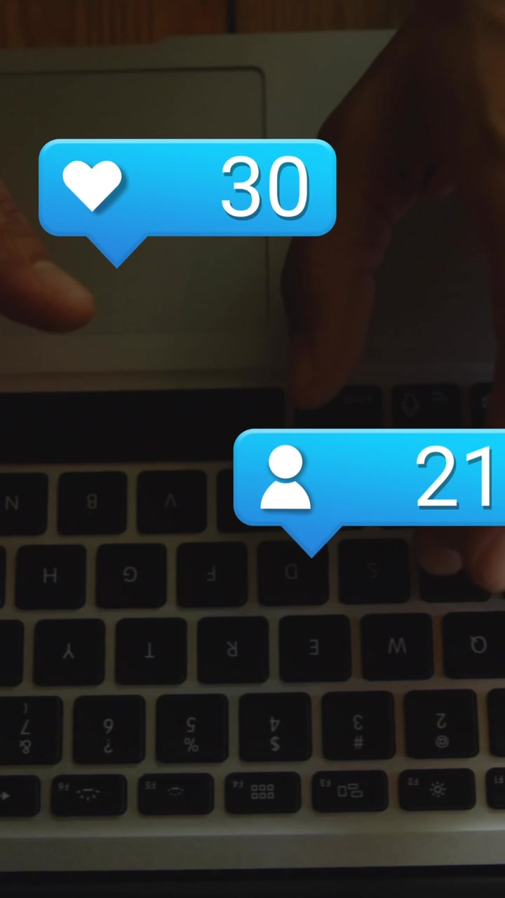 Animation of numbers and icons in message boxes, cropped hands of man using laptop