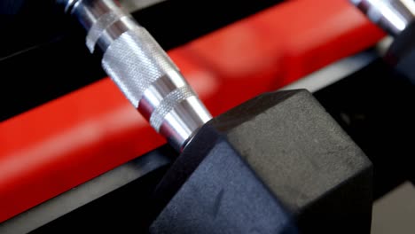 dumbbells on a rack in fitness studio 4k