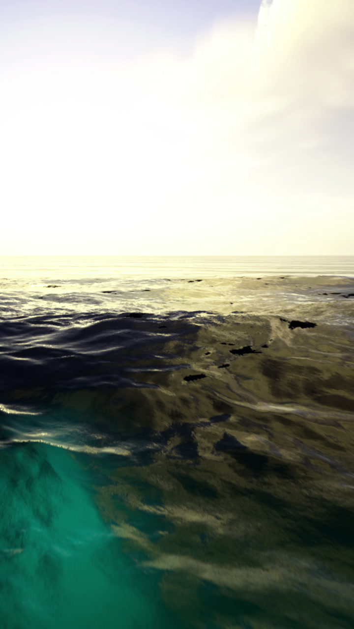 Waves dance gently under the soft glow of sunset at the tranquil sea