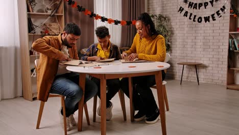 family making halloween decorations together