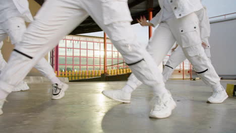 Legs-of-dancers-doing-choreography-in-white-trousers