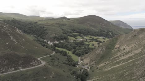 Capelulo-Penmaenmawr-Welsh-mountain-coastal-valley-aerial-view-north-wales-descending