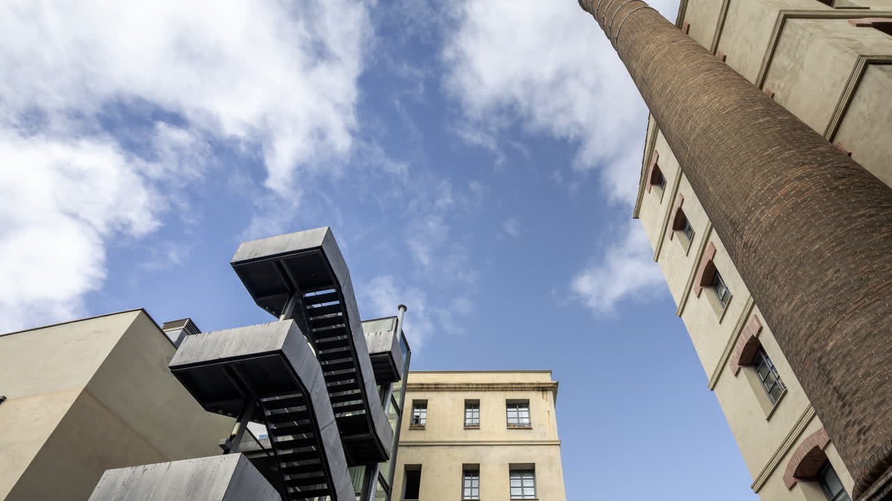 Old factory chimney and apartment buildings in barcelona
