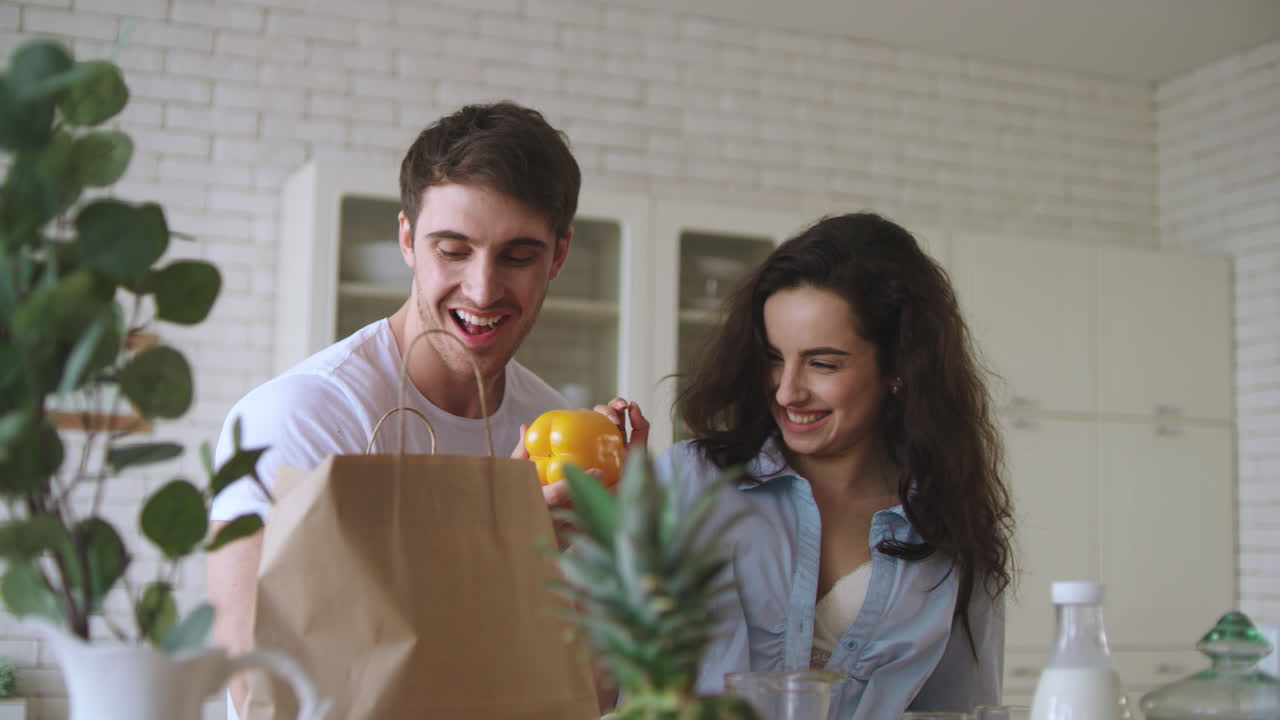 una pareja feliz divirtiéndose en la cocina.