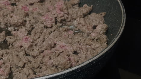 breaking up cooking ground beef in stovetop pan