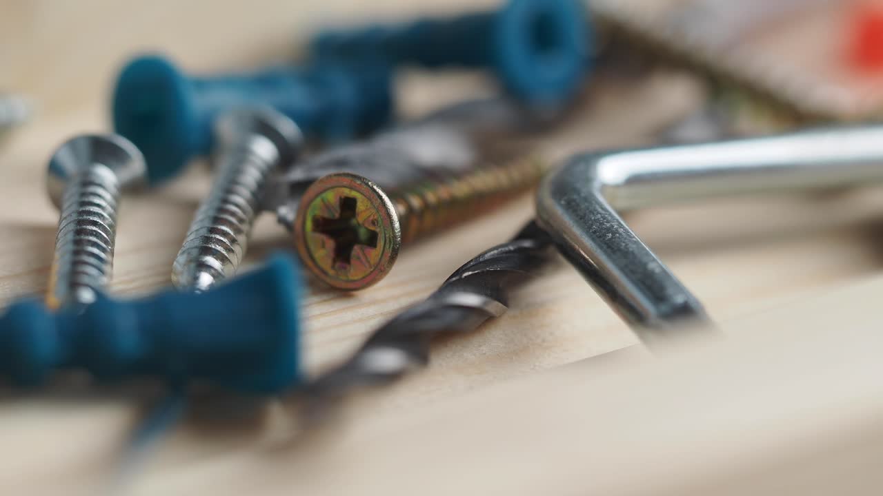 Close-up of Various Hardware Tools and Fasteners on Wood
