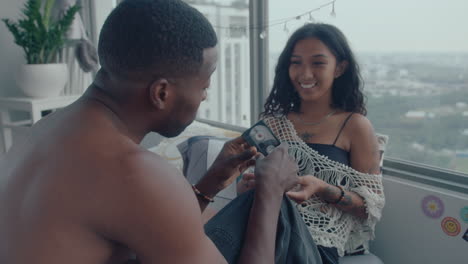 young couple choosing cassette to listen at home
