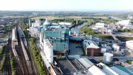 Industrial-chemical-manufacturing-factory-next-to-Warrington-Bank-Quay-train-tracks-aerial-view-slow-right-dolly