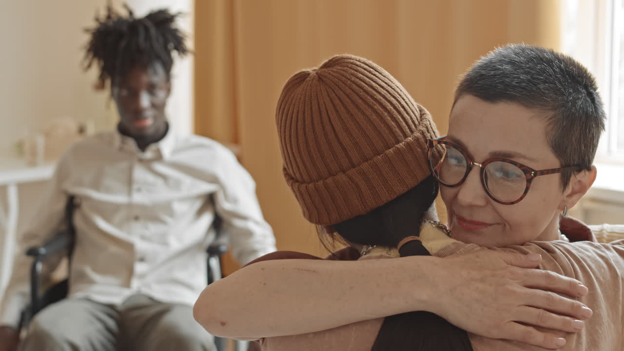 A group of people hugging and supporting each other
