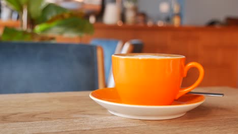 orange coffee cup in a cafe