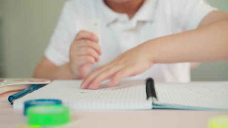 little boy swipes dirt after picture erasing from notebook