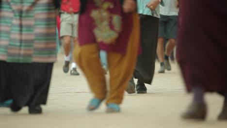 Sliding-shot-of-peoples-feet-walking-down-street