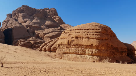 Pan-across-sand-and-wind-eroded-rock-formations-of-Wadi-Rum-desert