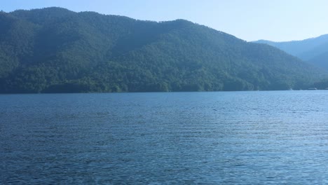 calm water with boats and mountain backdrop