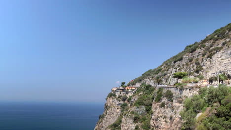 Locked-Off-View-Of-Cliff-Side-Next-To-Blue-Sky-And-Ocean-In-Amalfi-Coast,-Italy