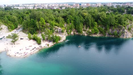 Tourists-At-Zakrzowek-Natural-Swimming-Pool-In-Krakow,-Poland---Aerial-Drone-Shot