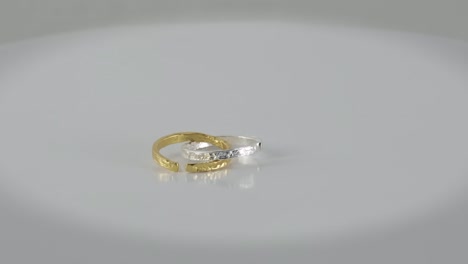irregular adjustable rotating golden and silver rings isolated on white background