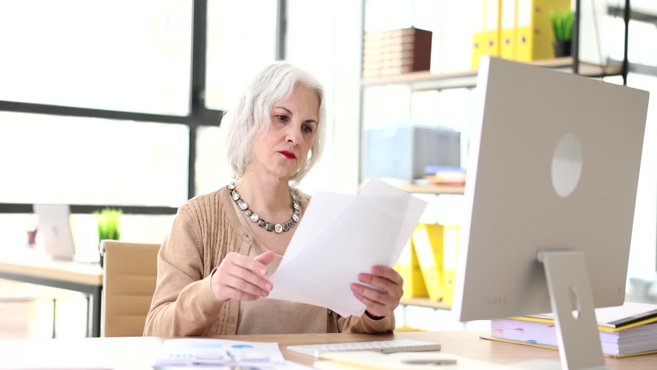 Mature woman working in office