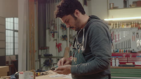 woodworker oiling wooden drink coaster