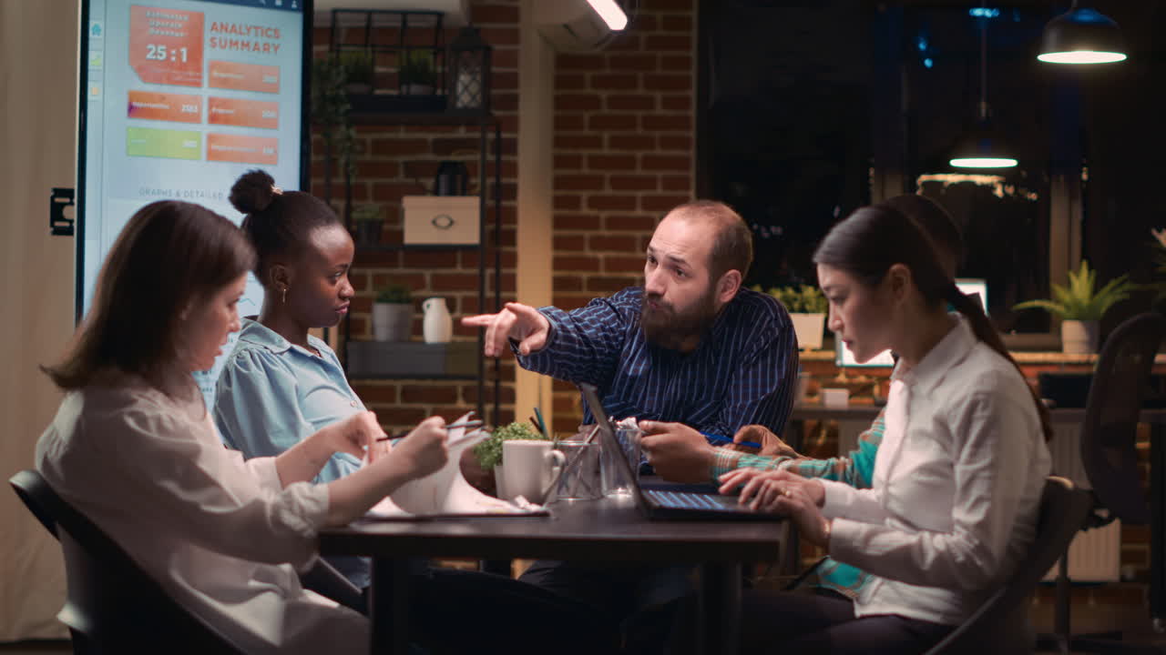 Coworkers brainstorming, listening to team leader in business meeting