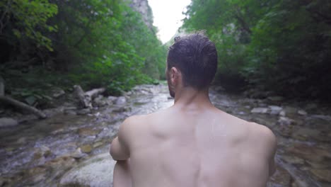 the man watching the nature in the creek.