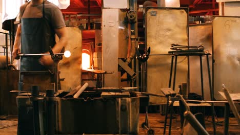 glassblower shaping a molten glass