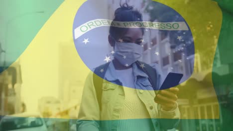 Animation-of-flag-of-brazil-waving-over-woman-in-face-masks