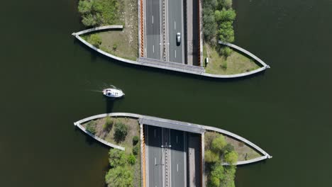 aquaduct veluwemeer water bridge with boat crossing above highway traffic, aerial view