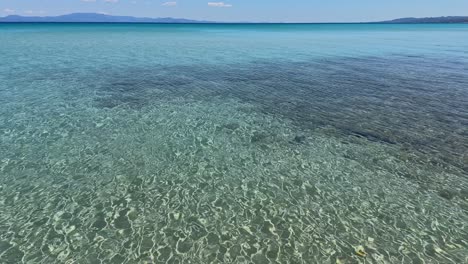 stunning beach scene in halkidiki, greece, with elegant sunbeds facing the crystal-clear turquoise sea. a perfect summer escape in the heart of the aegean.