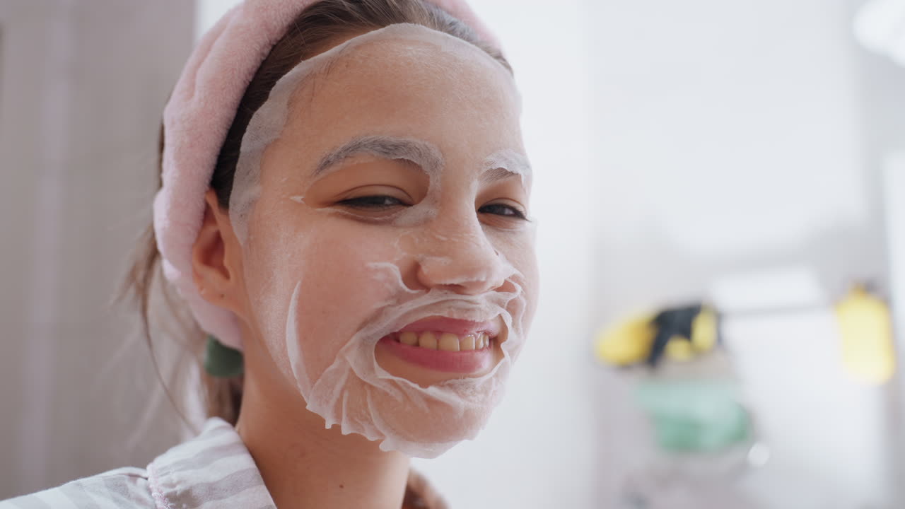 Joyful Lady With Skincare Mask, Lively Young Woman In Bathroom Amused By Skincare Mask Moment, Vivacious Female Engaging In Cheerful Skincare Activity During Bright Morning In Bathroom