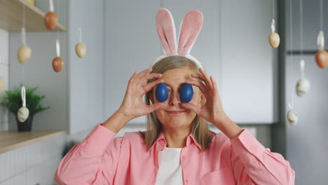 woman with easter bunny ears and blue eggs
