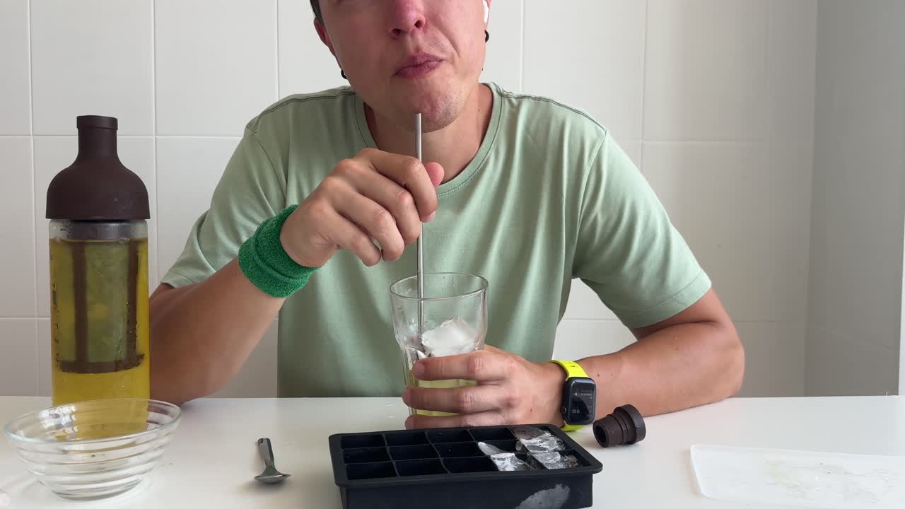 Homem Servindo e Bebendo uma Bebida Gelada com um Canudo