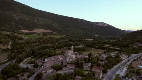 the chapel notre-dame de la consolation, built in 1894 atop a rocky spur overlooking a village in pierrelongue