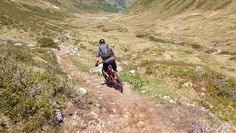 cross country mtb mountain biking on a nice enduro single trail with amazing alpine mountain landscape in tirol austria