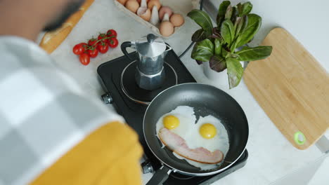 person cooking breakfast