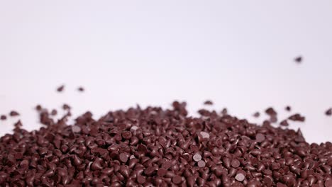 chocolate chips cascading onto a growing pile