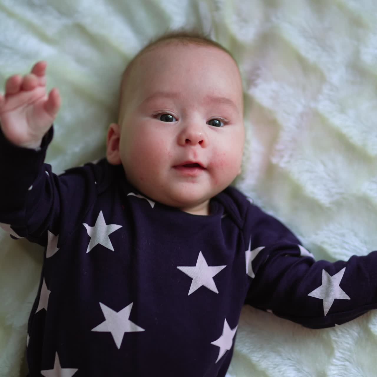 Gorgeous little baby lies on the bed. Cute small newborn boy