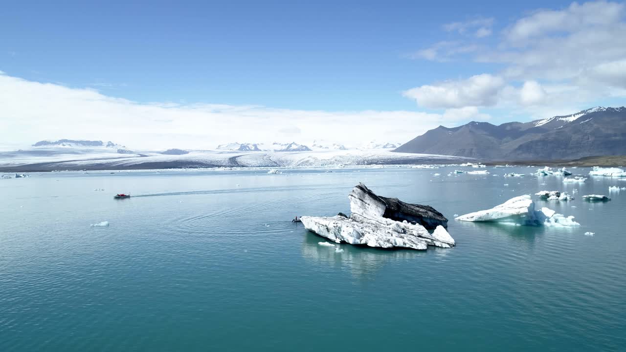 Icebergs and Boat on Glacier Lake in Iceland