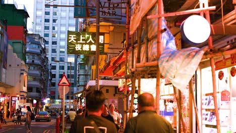 people walking through vibrant hong kong night market